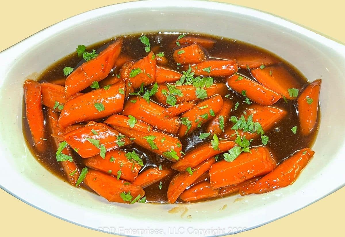 Finished Cane-Glazed Carrots served in a bowl with glossy cane glaze and parsley garnish.