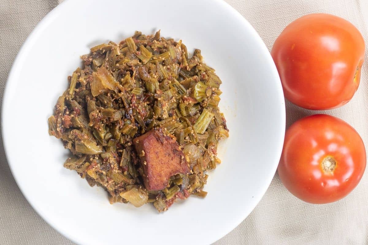 Tender smothered okra and tomatoes served Louisiana-style with smoky ham.