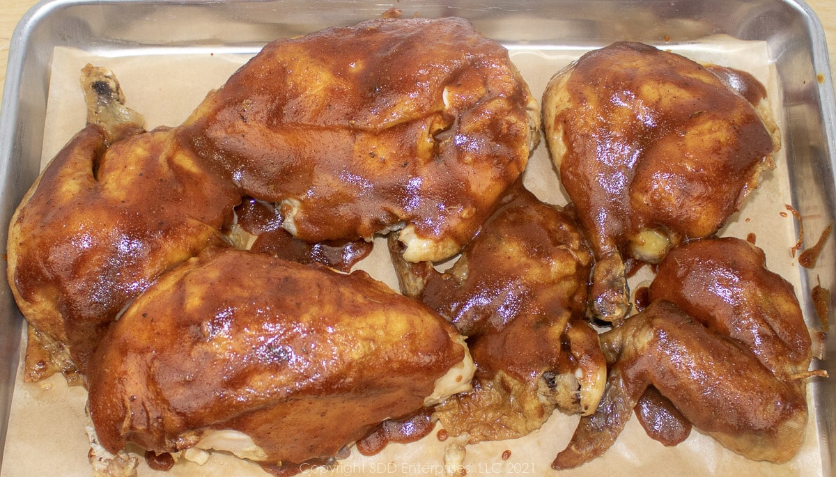 Grilled chicken glazed with homemade BBQ sauce on a serving platter.