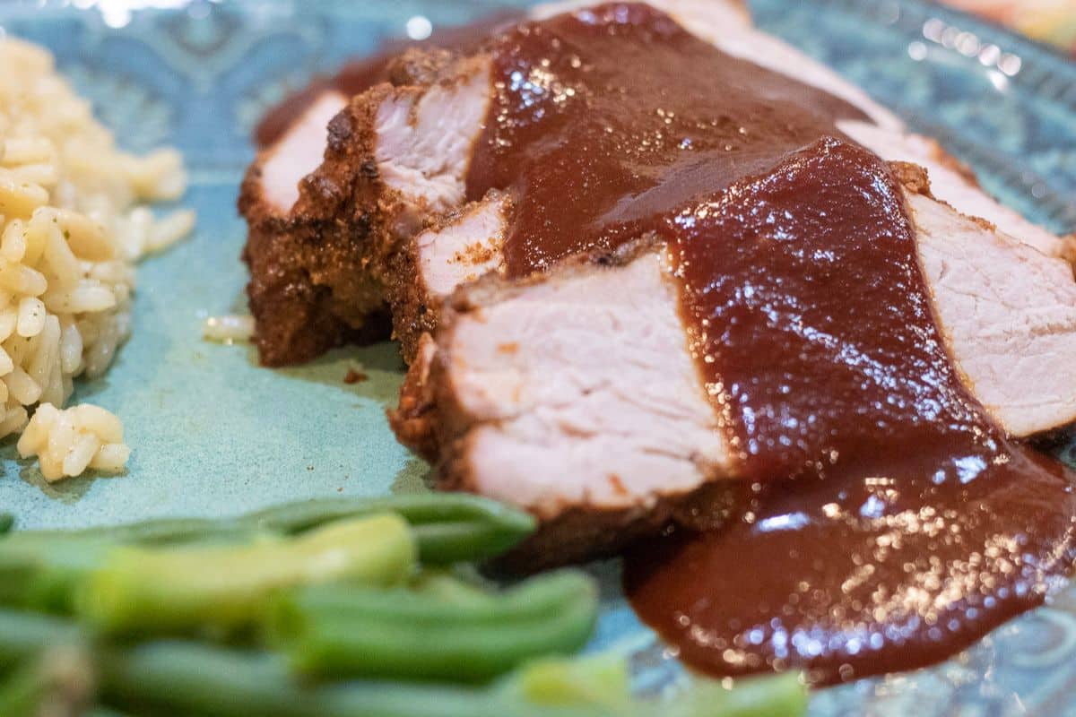 Homemade Cranberry BBQ Sauce served over sliced pork tenderloin.