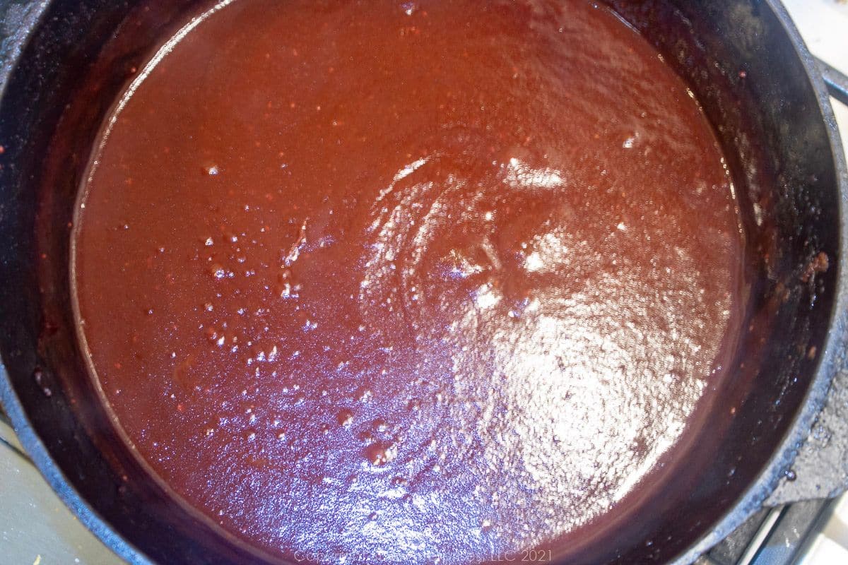 Homemade BBQ Sauce simmering on in a Dutch oven.