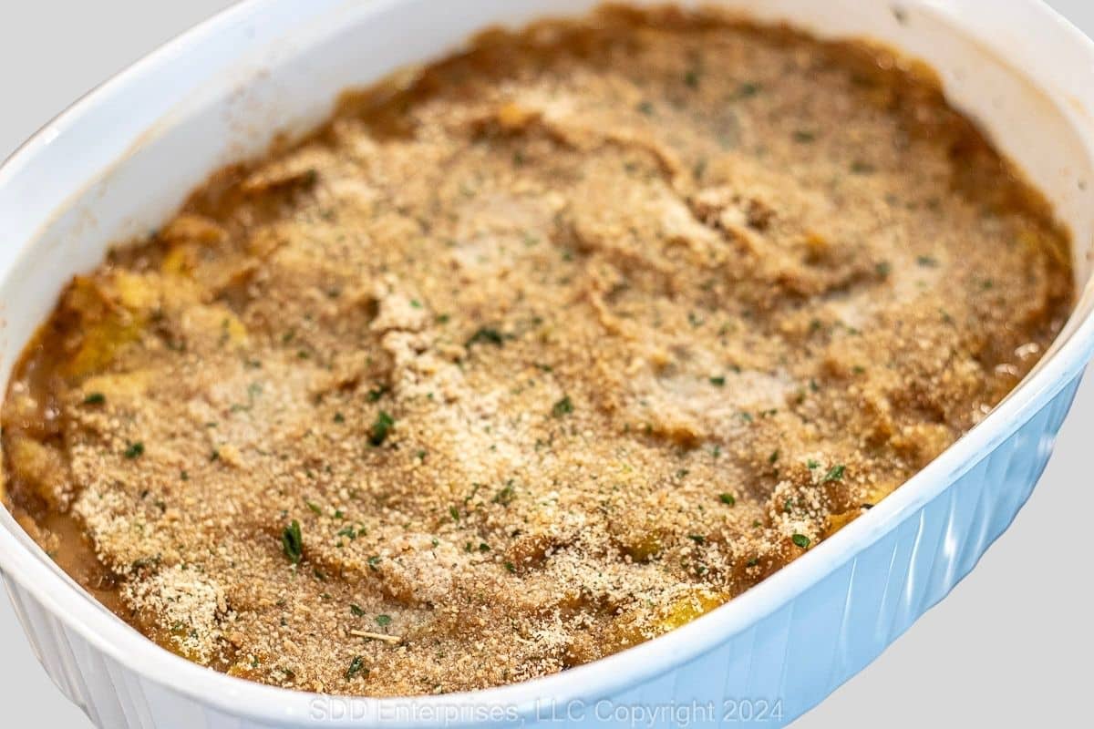 Baked yellow squash casserole with a lightly browned breadcrumb topping.