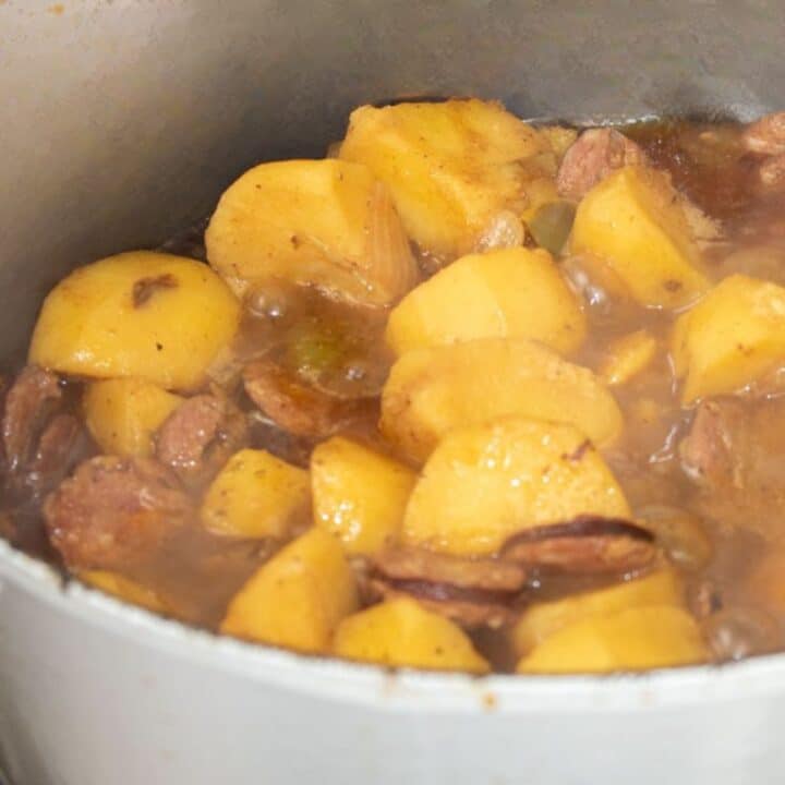 Smothered Potatoes with Sausage in a Dutch oven.