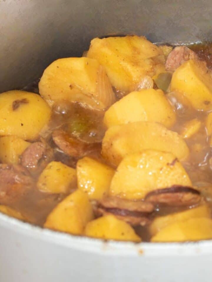 Smothered Potatoes with Sausage in a Dutch oven.
