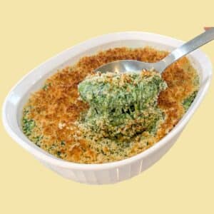 Creamed Spinach with breadcrumb topping being served from a baking dish.