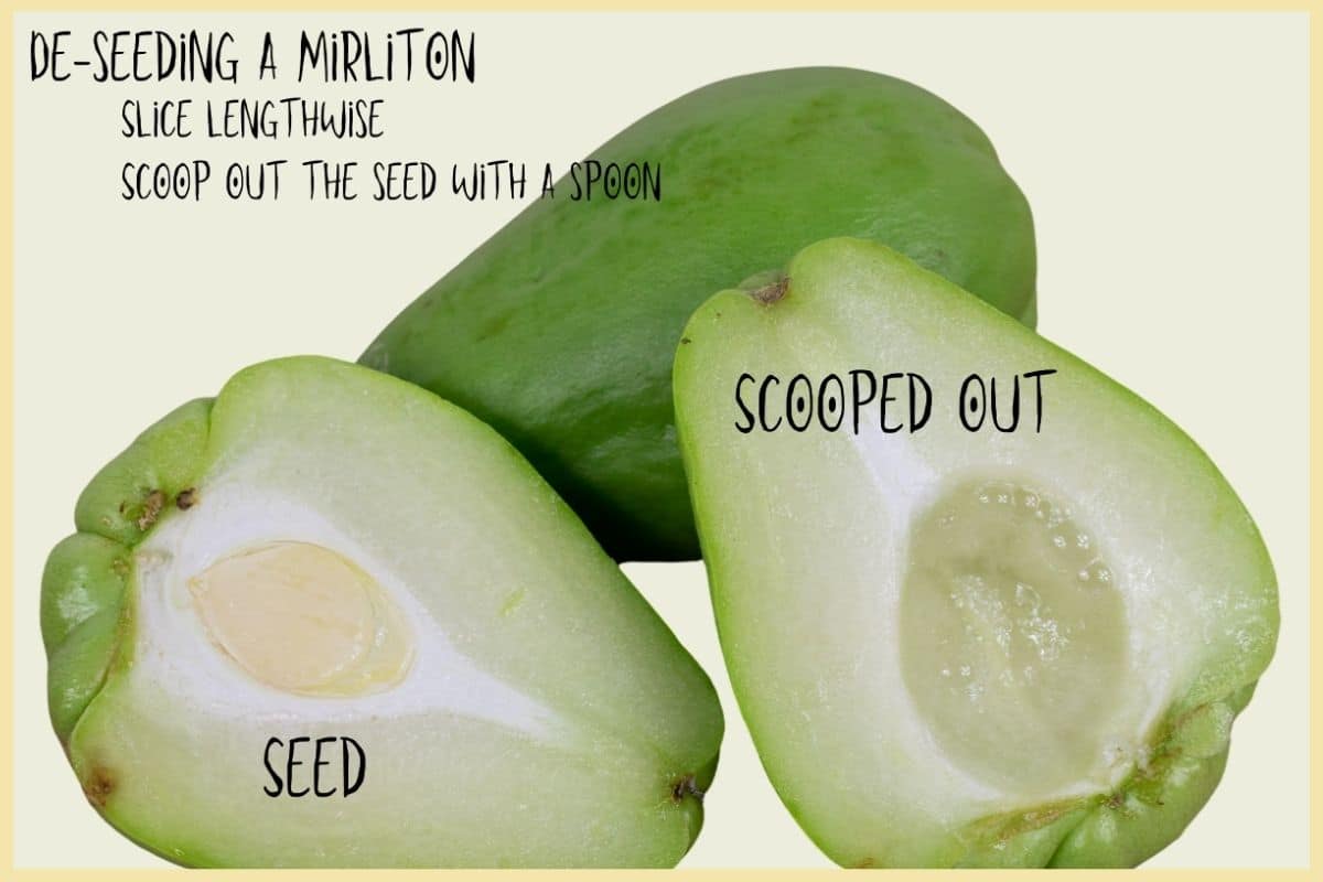 Mirliton sliced lengthwise showing the seed in one half and the scooped-out cavity in the other
